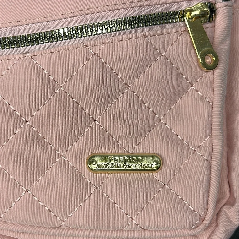 Pink Cross Body Backpack with gold zipper pockets